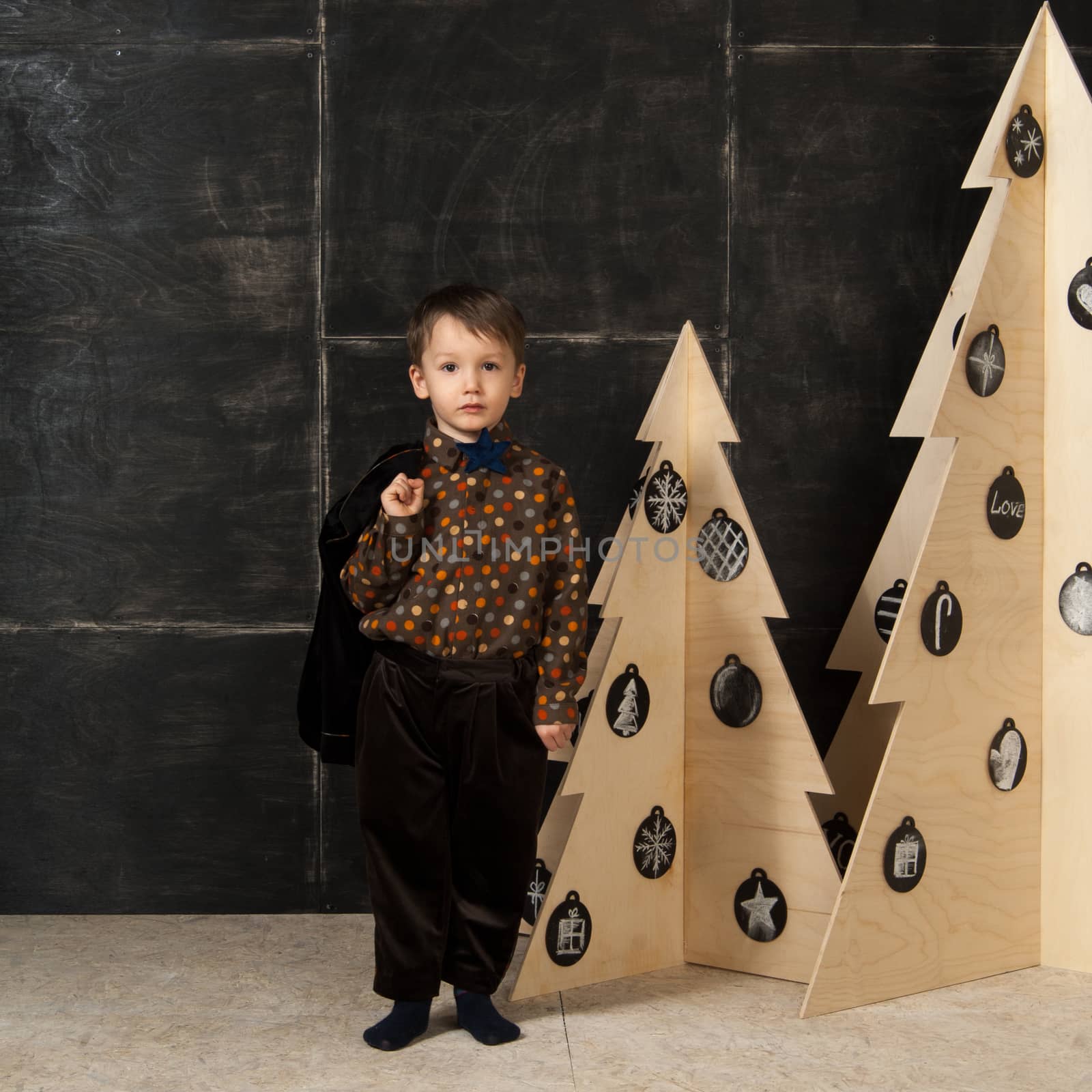 the little boy next to decorative Christmas trees by A_Karim