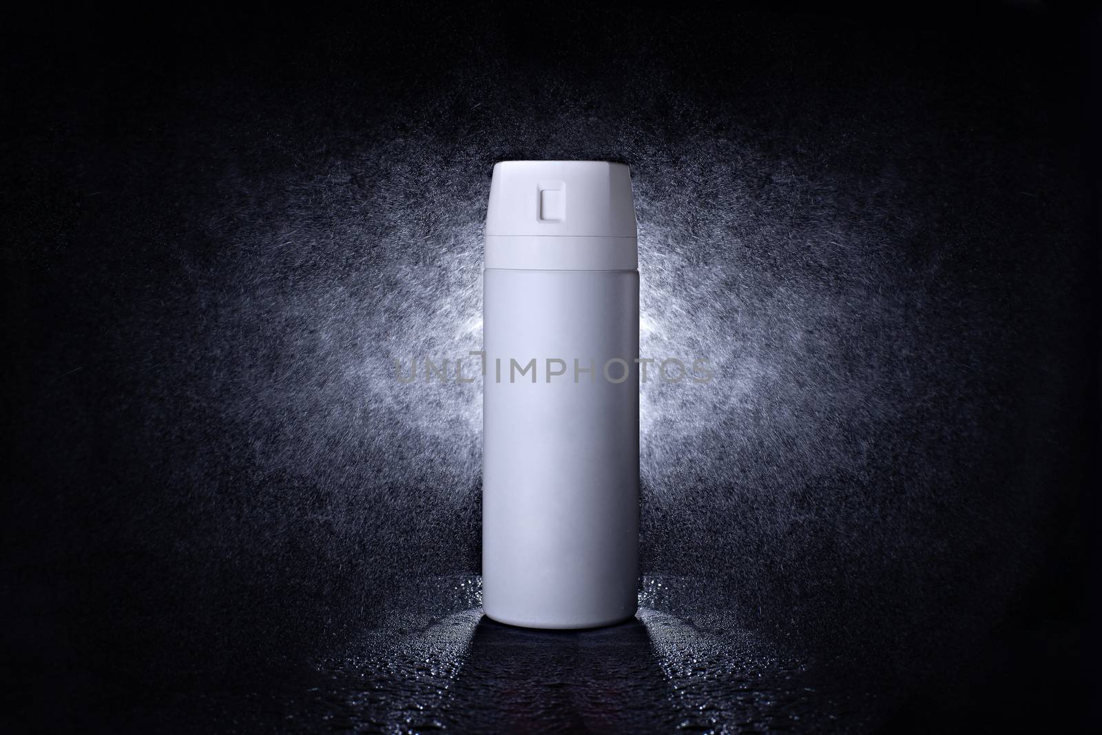 Deodorant in a black metal can on a black background with splashes at the back. Advertising photo of an aerosol antiperspirant. Mock up bottle with spray of water.