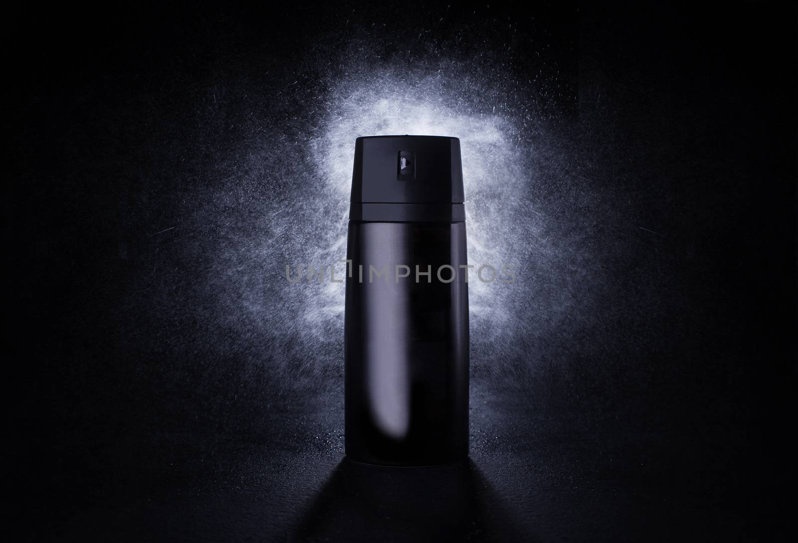 Deodorant in a black metal can on a black background with splash by Opikanets