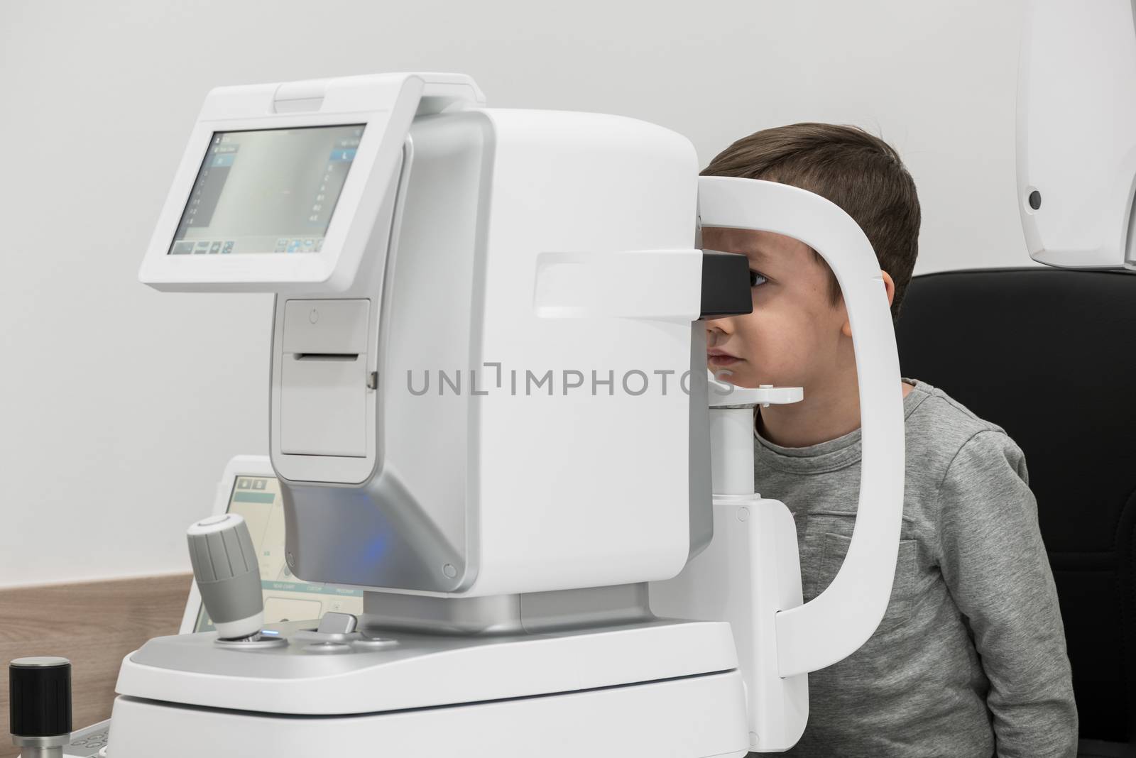 the boy is the patient on reception at doctor ophthalmologist. diagnostic ophthalmologic equipment. medicine concept