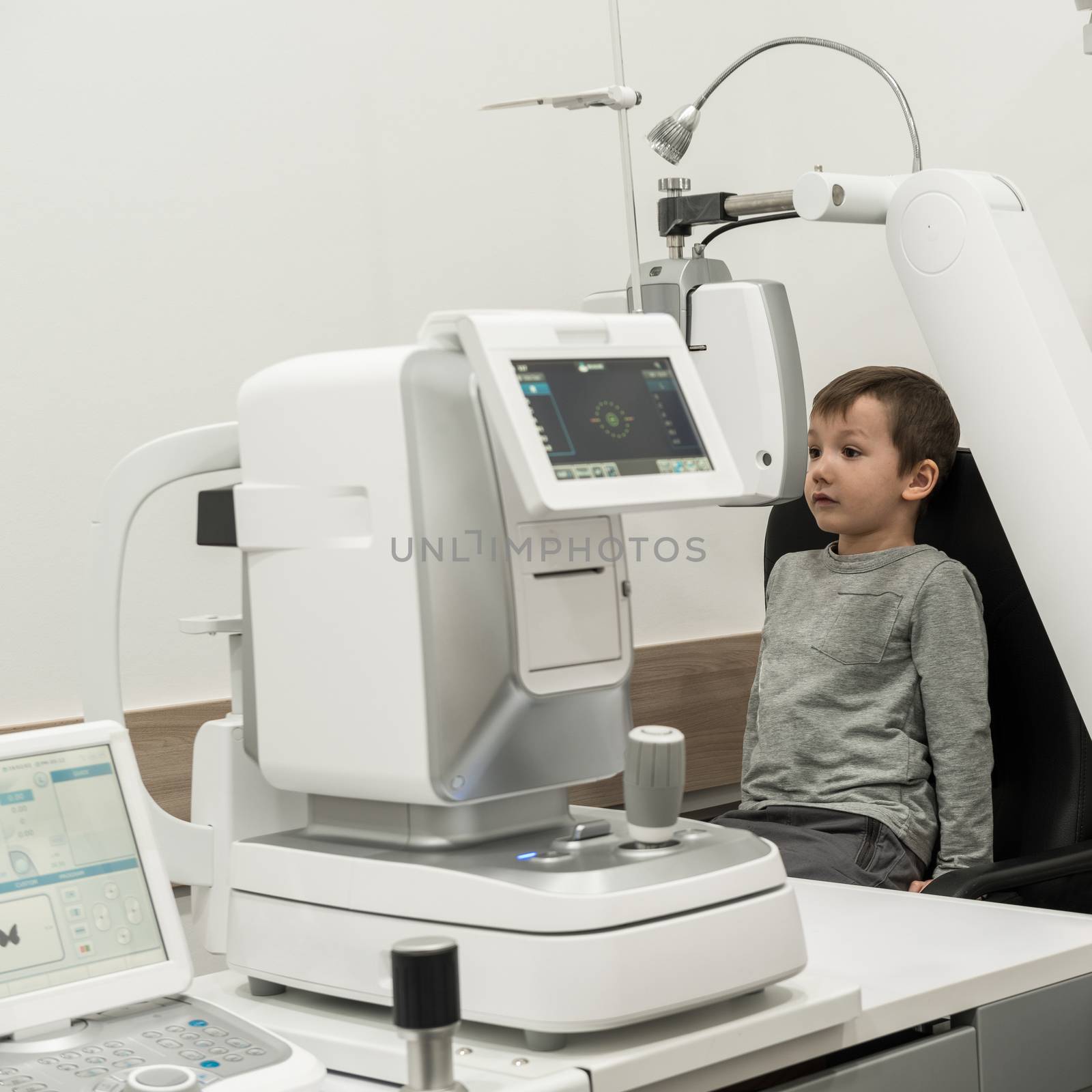 the boy is the patient on reception at doctor ophthalmologist. diagnostic ophthalmologic equipment. medicine concept