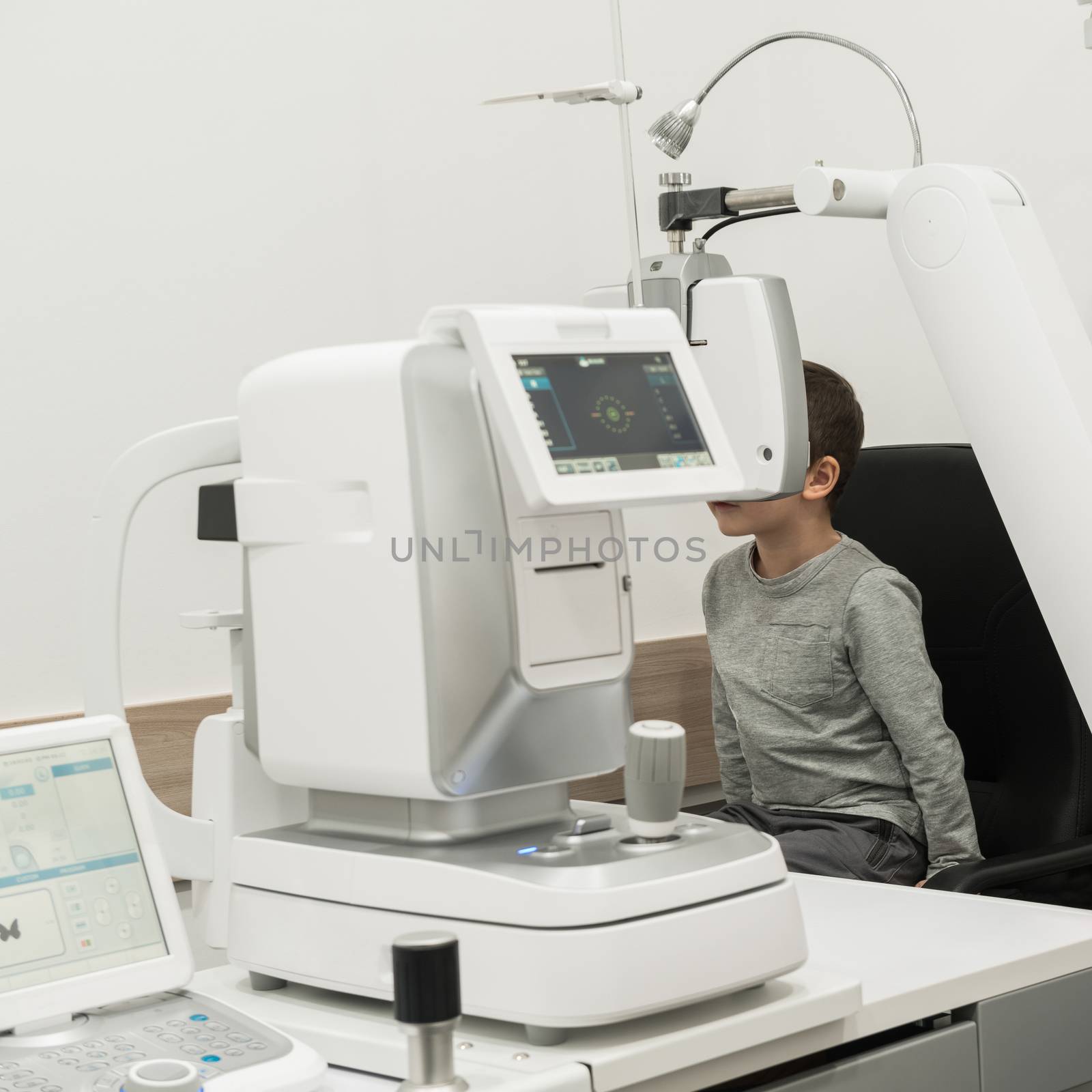the boy is the patient on reception at doctor ophthalmologist. diagnostic ophthalmologic equipment. medicine concept