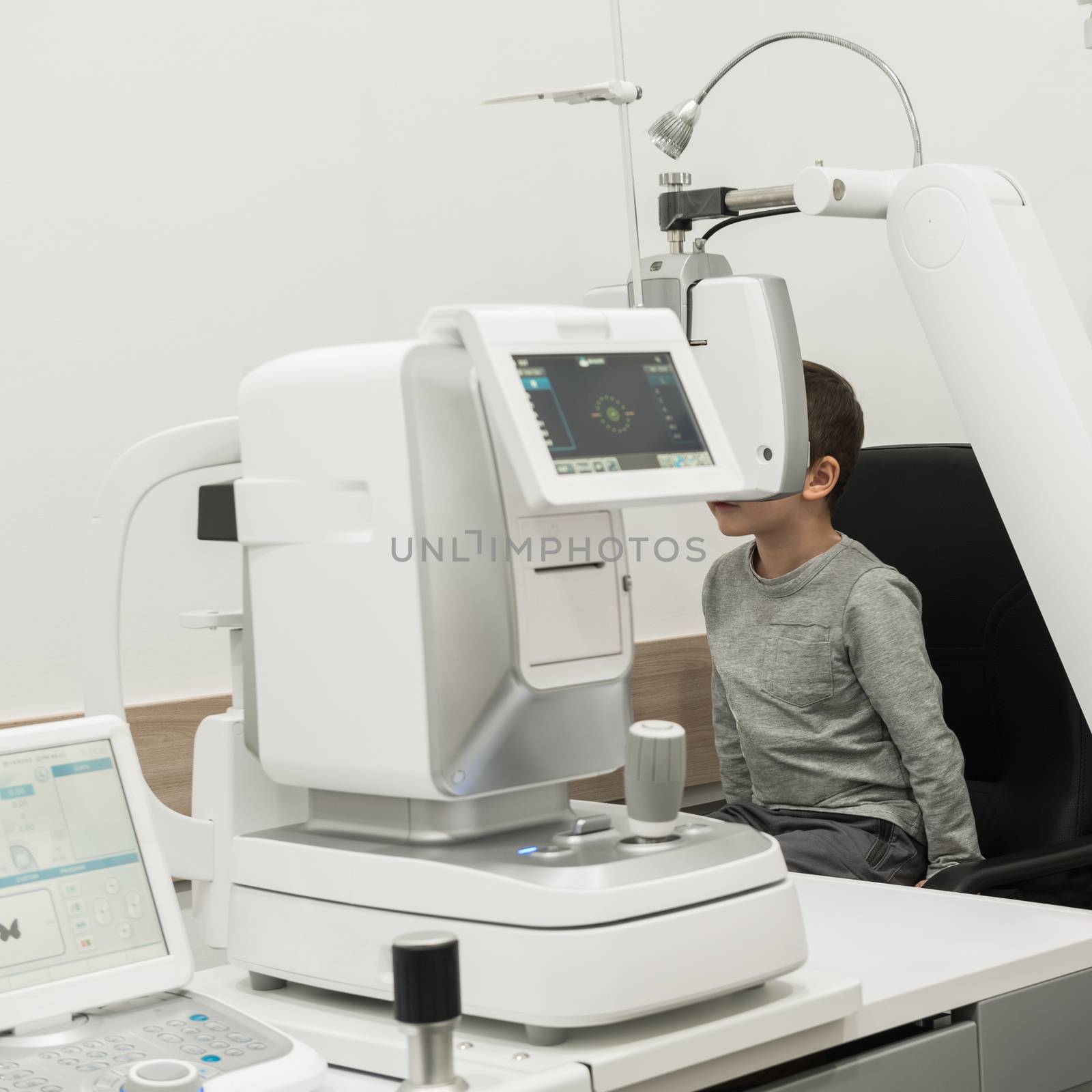 the boy is the patient on reception at doctor ophthalmologist. diagnostic ophthalmologic equipment. medicine concept