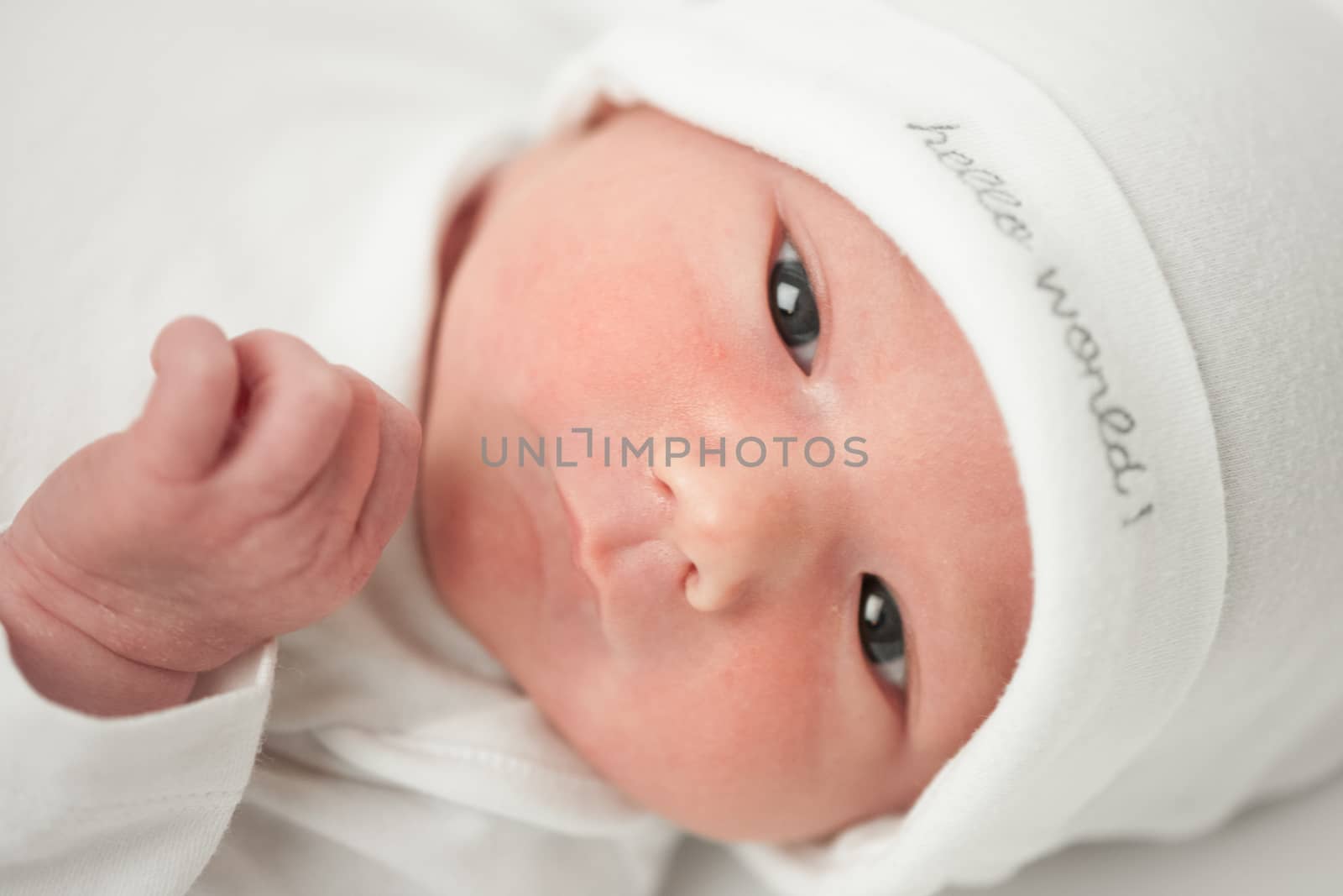 face baby in a white hat on a white background