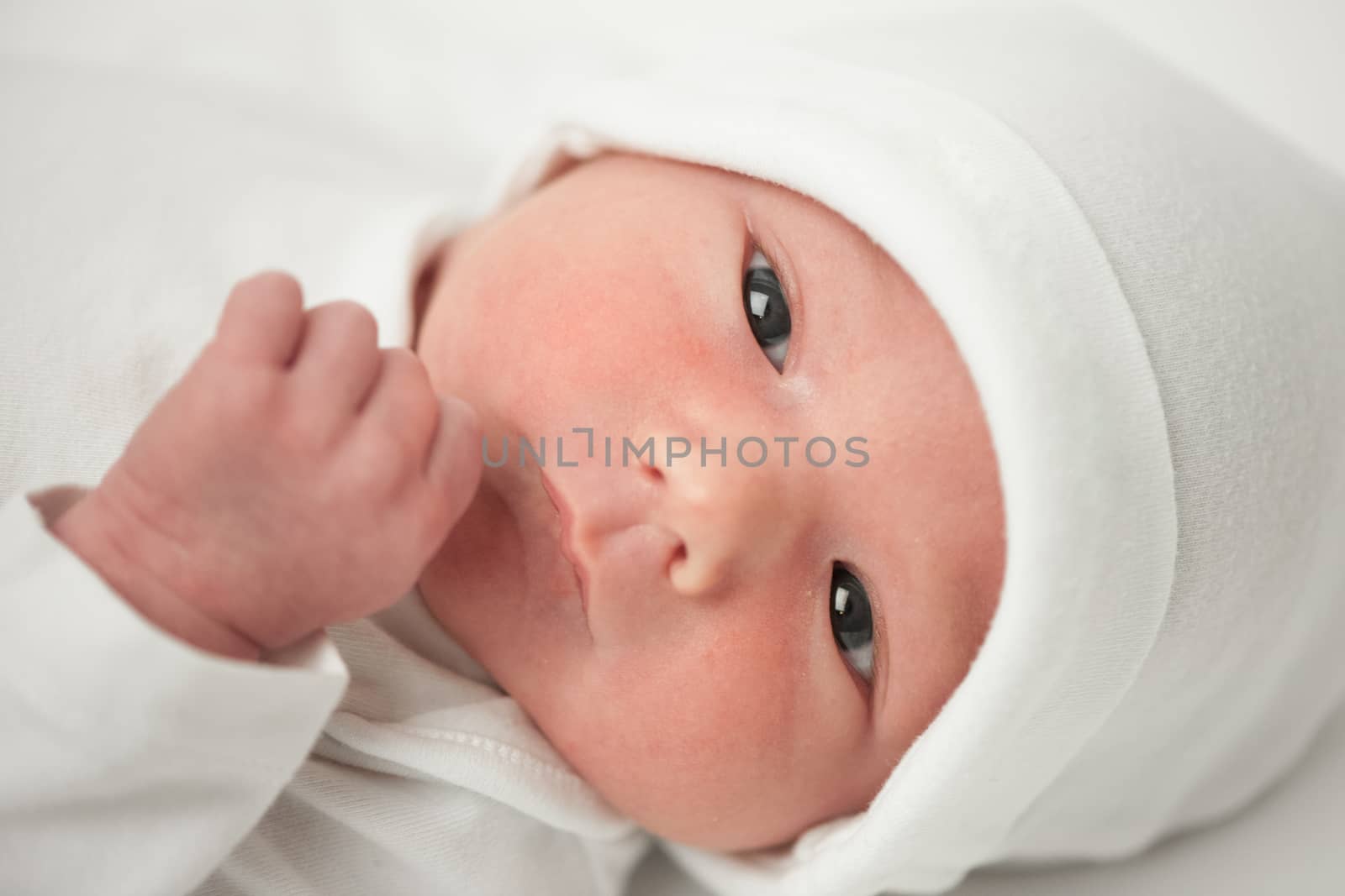 face baby in a white hat on a white background