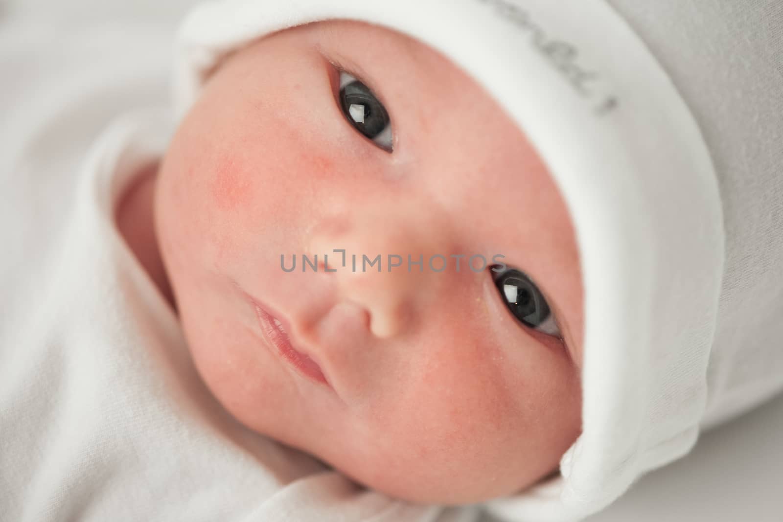 face baby in a white hat on a white background