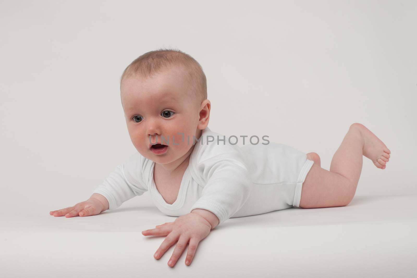 baby on a white background in a white pajamas