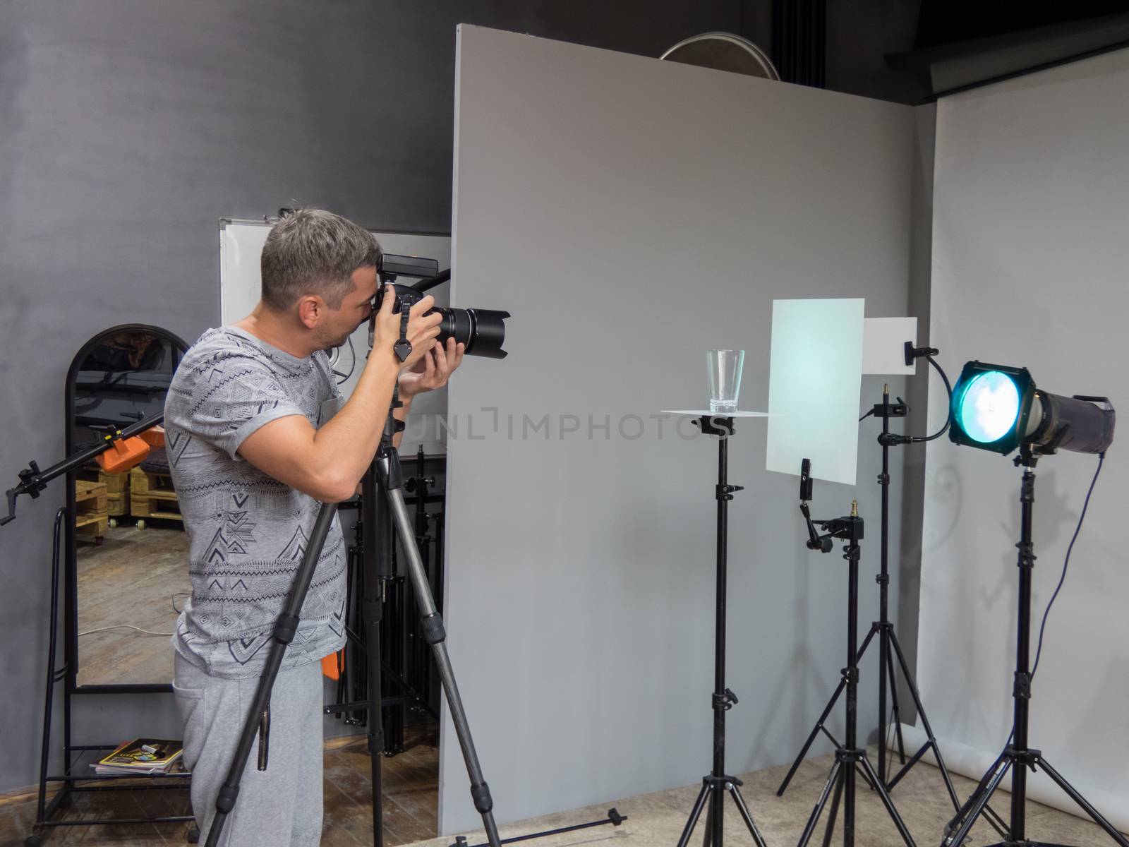 a young photographer in the process of working in a photography studio. unintended photography