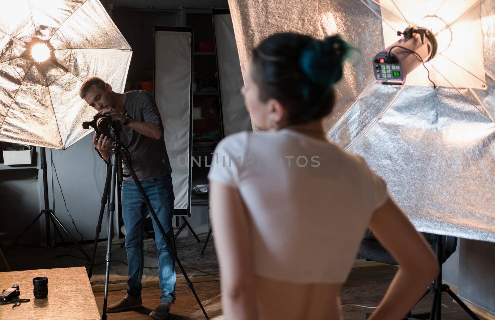 photographer in the process of shooting a model in a photo Studio