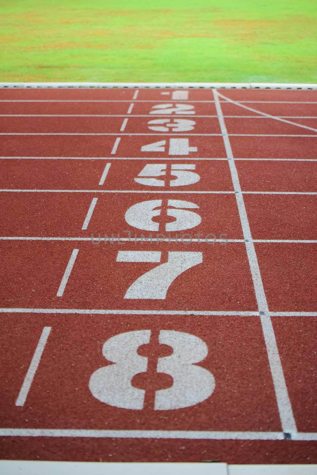 Athlete running track with number on the start . Perspective by photobyphotoboy