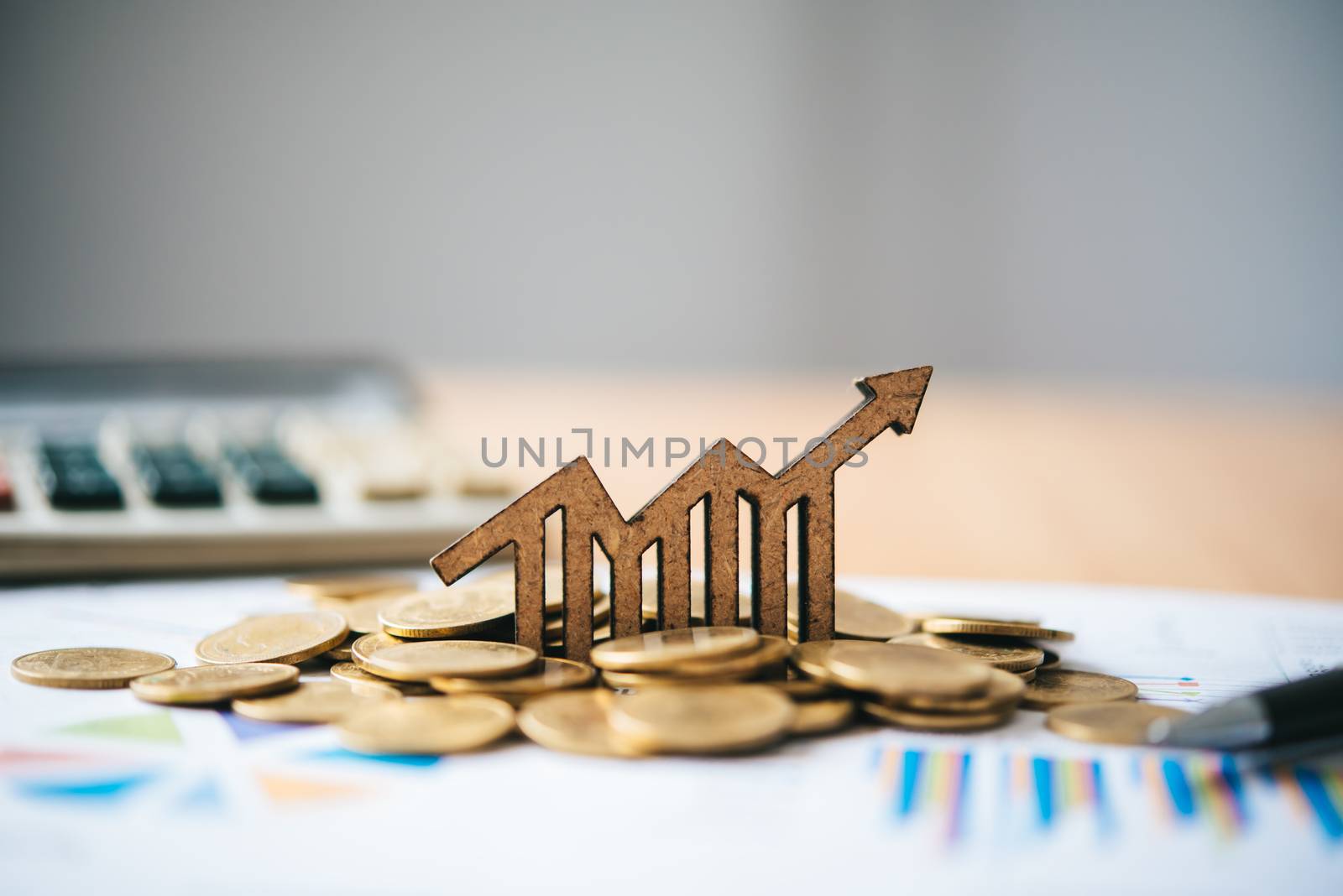 Graph icons placed on coins-Concept of business goals. by photobyphotoboy