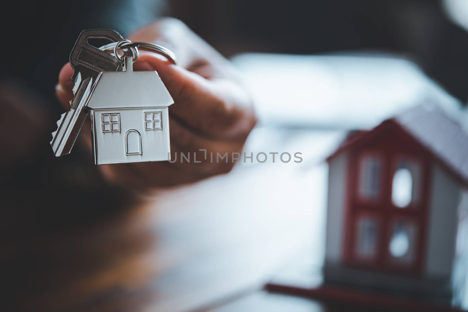 Salesperson Holding house keys concept, house keys for new house, new house purchase