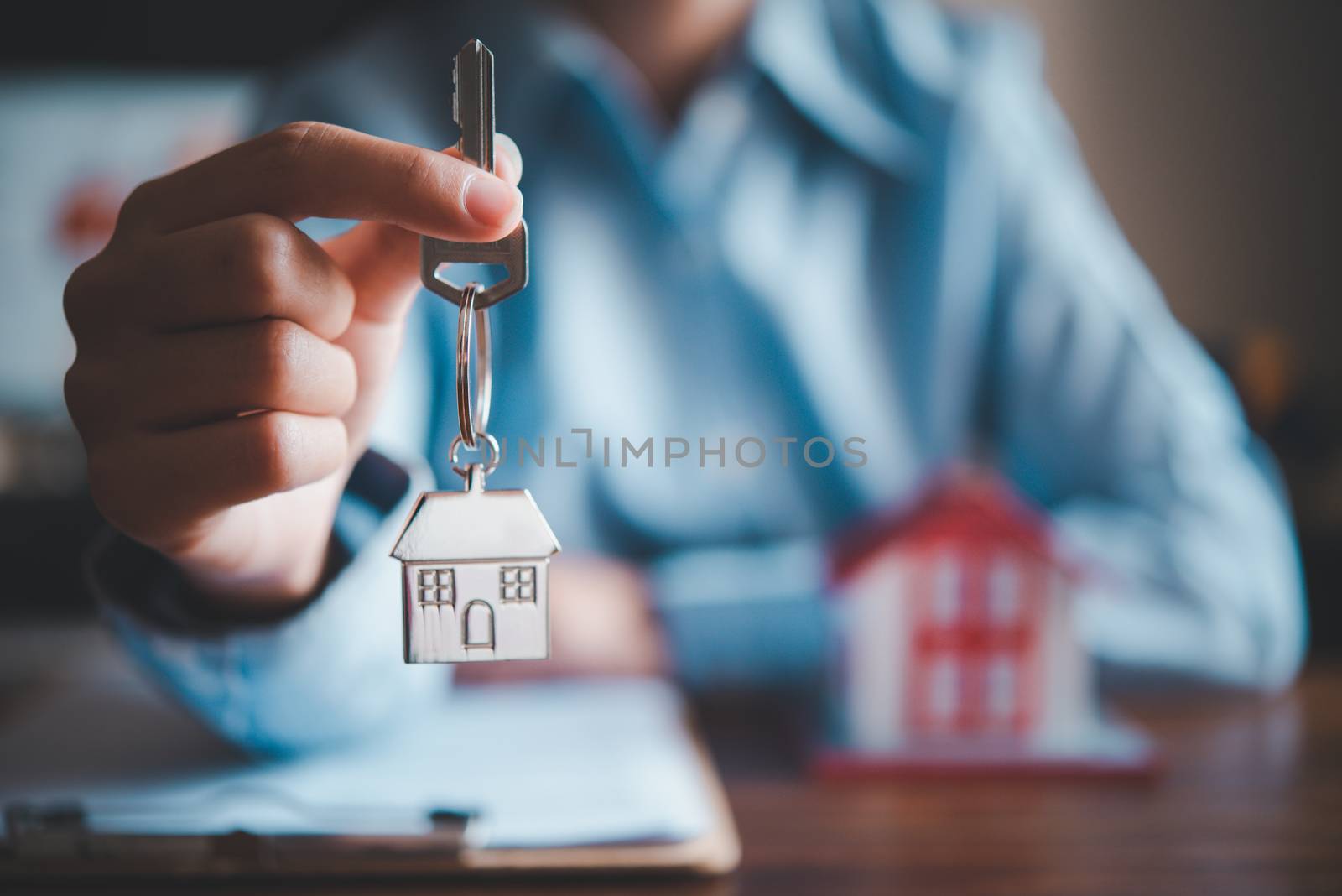 Salesperson Holding house keys concept, house keys for new house by photobyphotoboy
