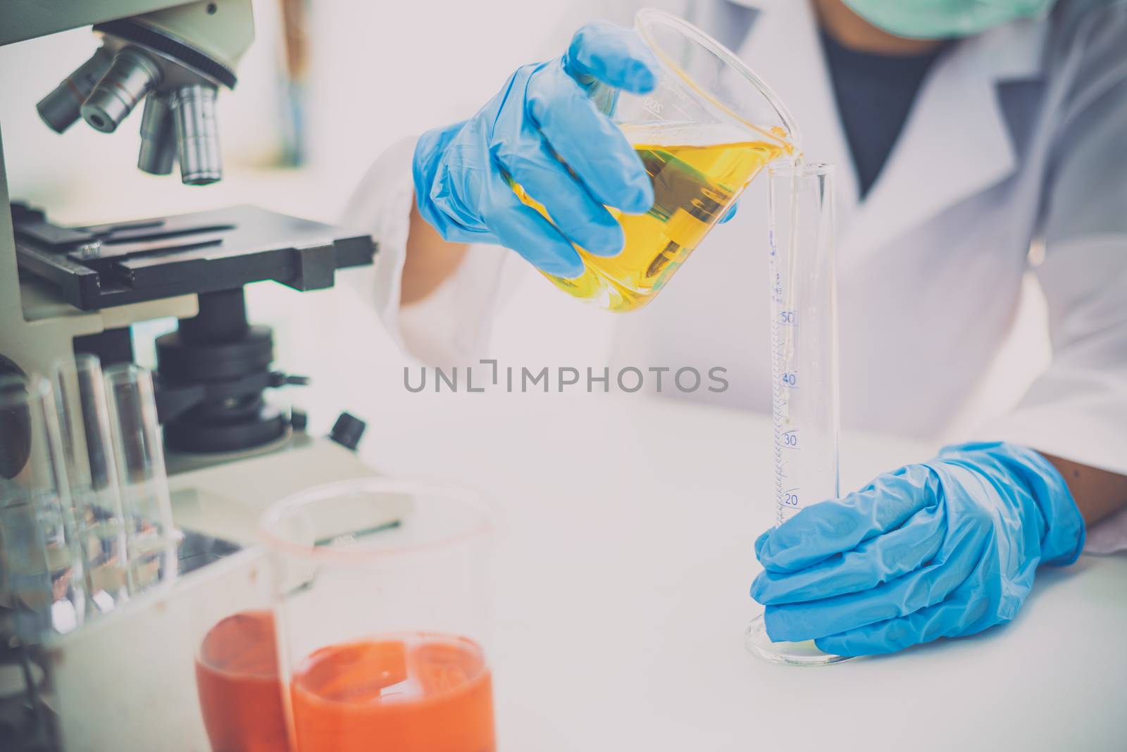 Young woman researcher doing experiment equipment and science ex by photobyphotoboy