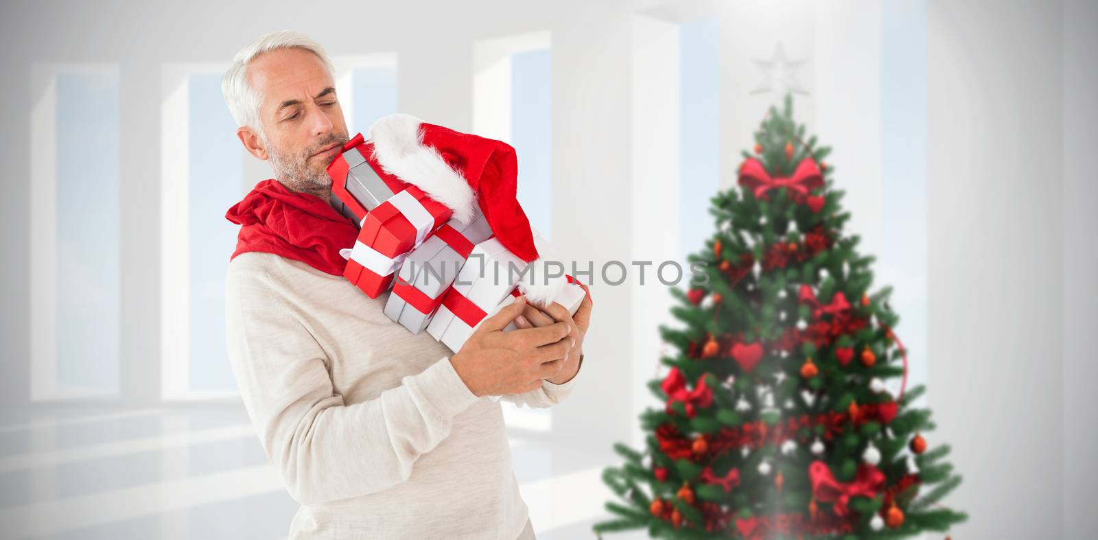 Composite image of happy festive man with gifts by Wavebreakmedia