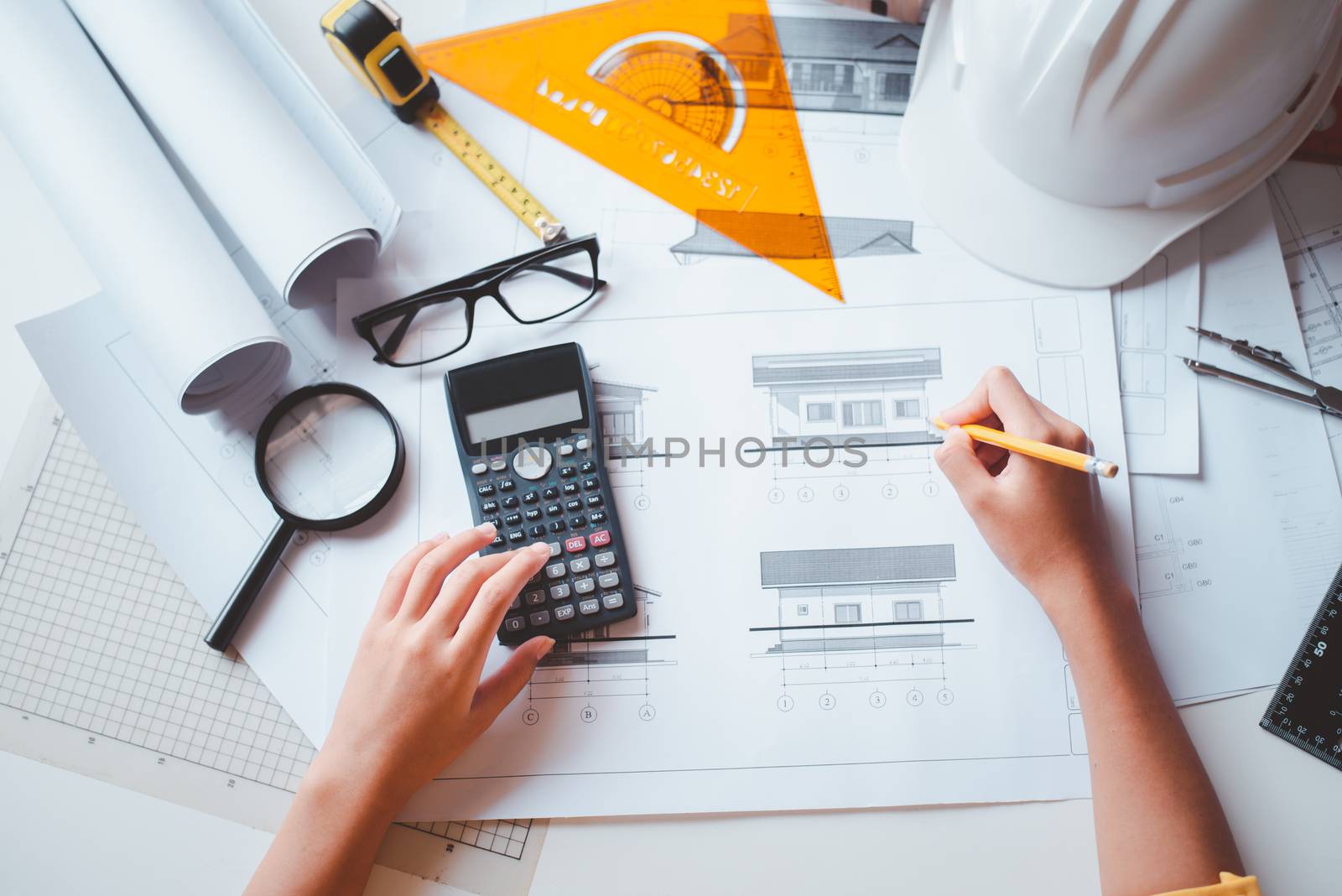  engineer working in office with blueprints, inspection in workp by photobyphotoboy
