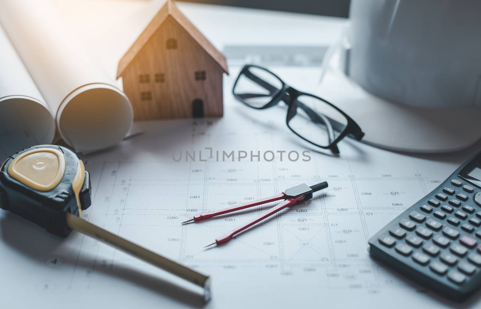  red dividers are placed on the work desk, with house plans desi by photobyphotoboy