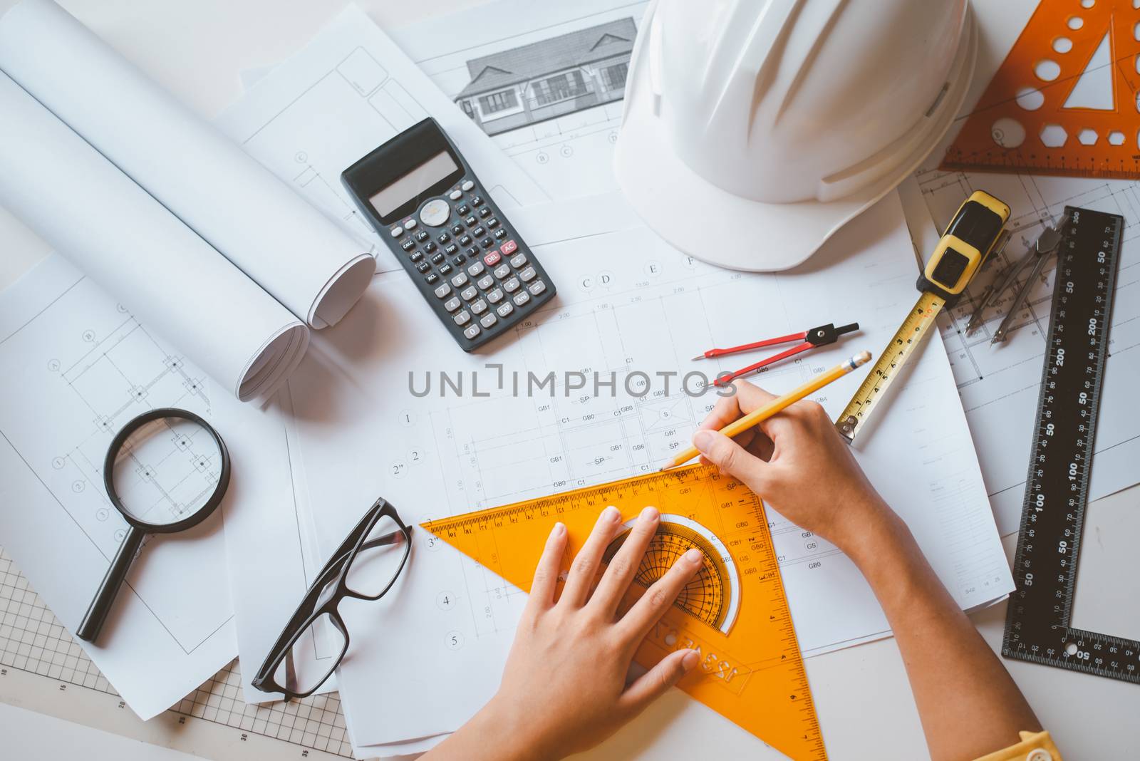  engineer working in office with blueprints, inspection in workp by photobyphotoboy