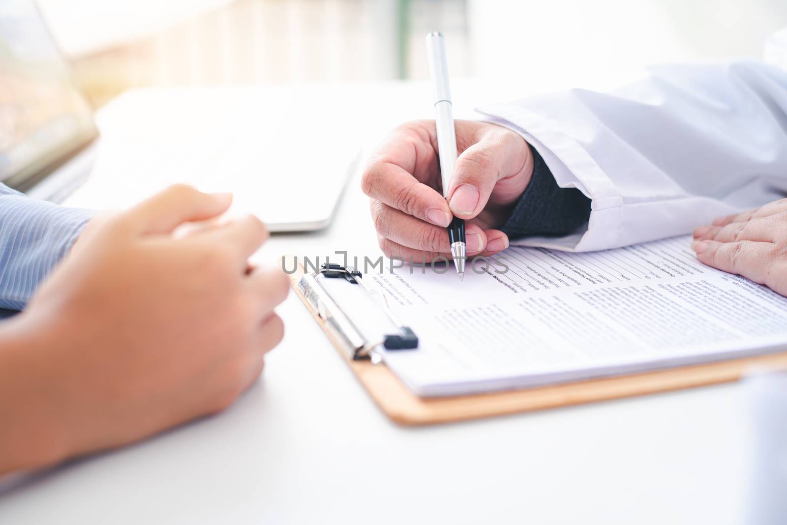 The doctor is discussing with the patient after a physical examination of the results and treatment 