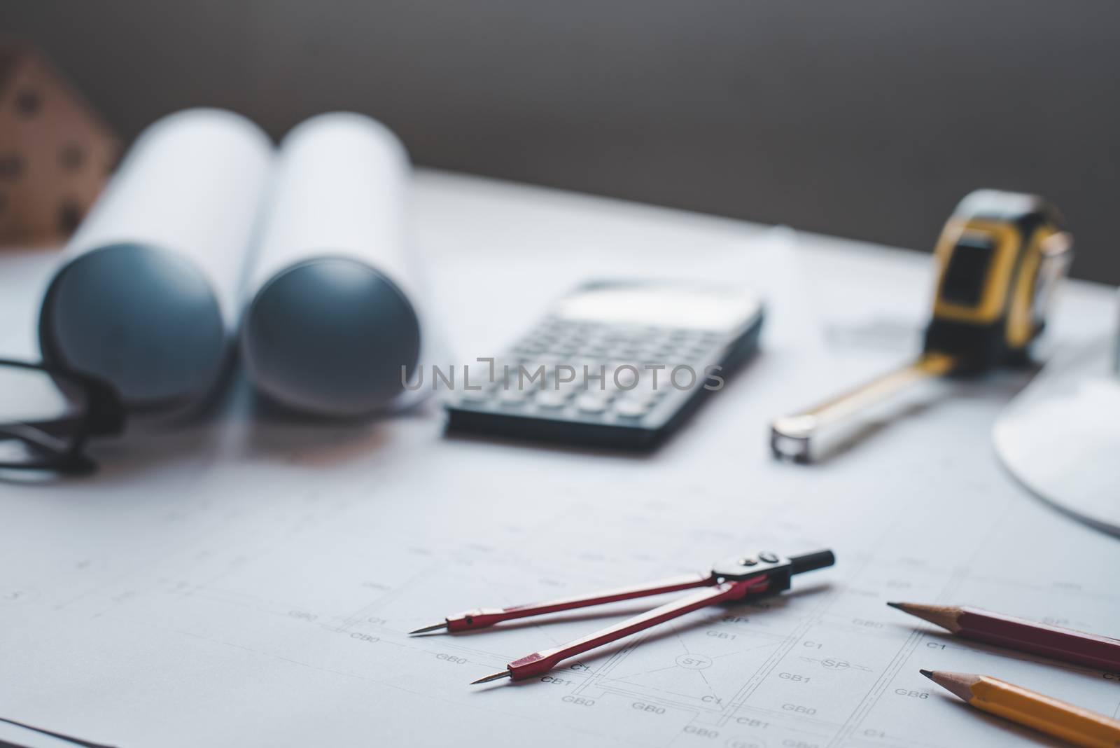  red dividers are placed on the work desk, with house plans desi by photobyphotoboy