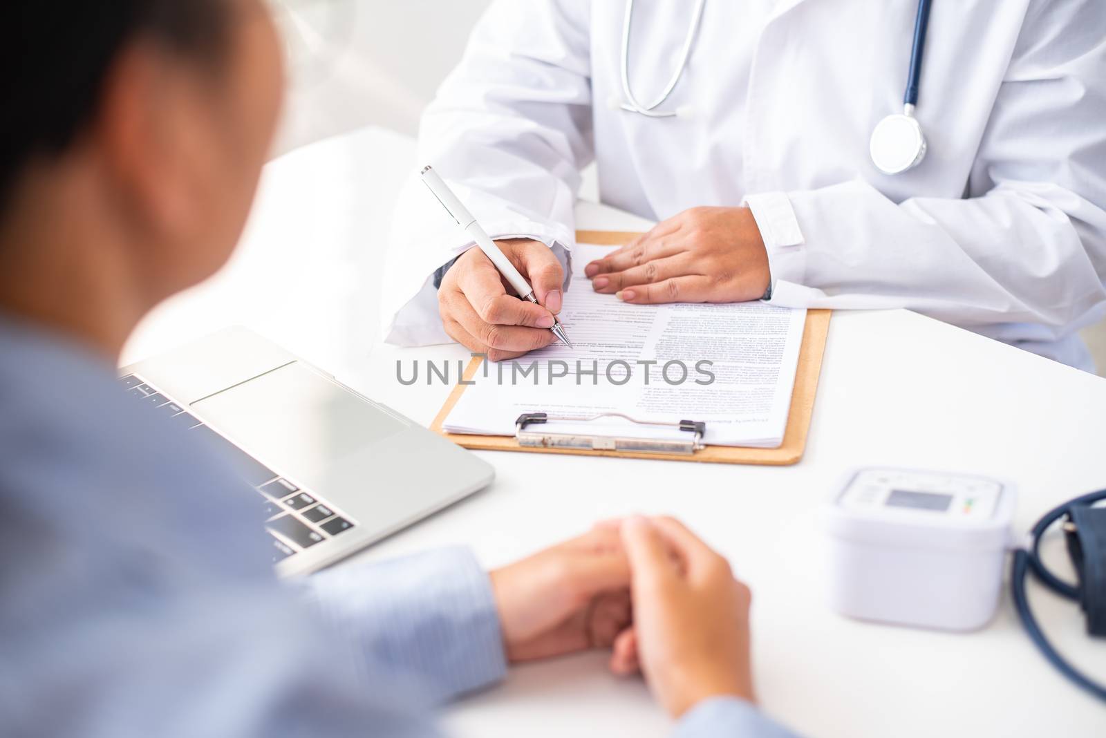 The doctor is discussing with the patient after a physical examination of the results and treatment 
