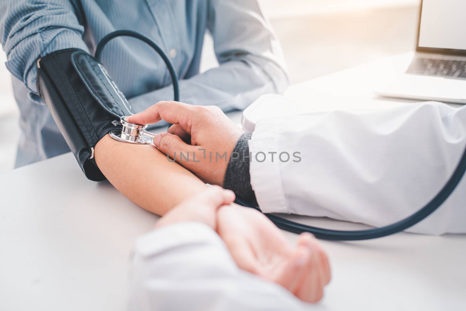 doctor measuring blood pressure from her patient