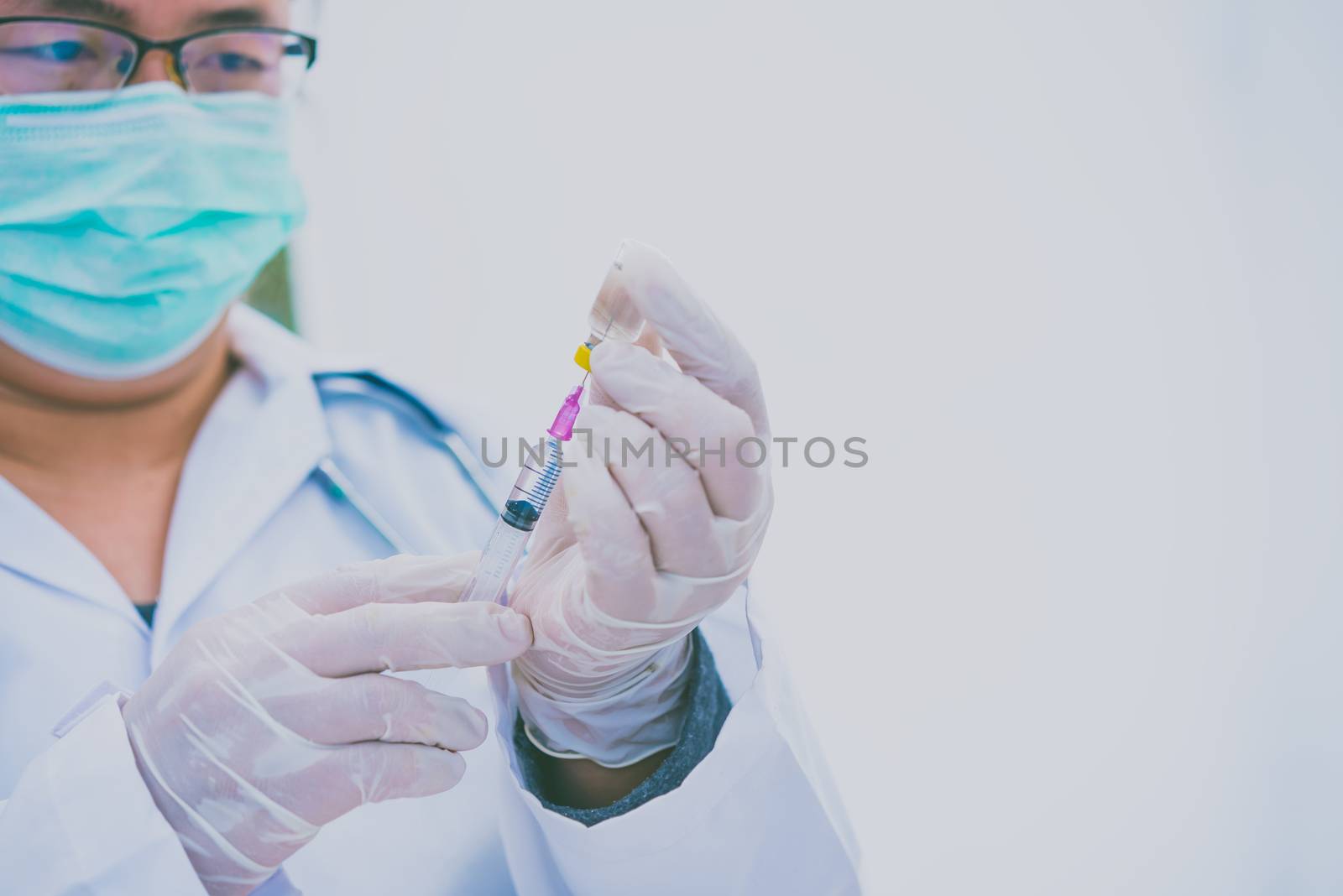 Doctor with syringe ready for injection of vaccine to patient. Vaccination concept.