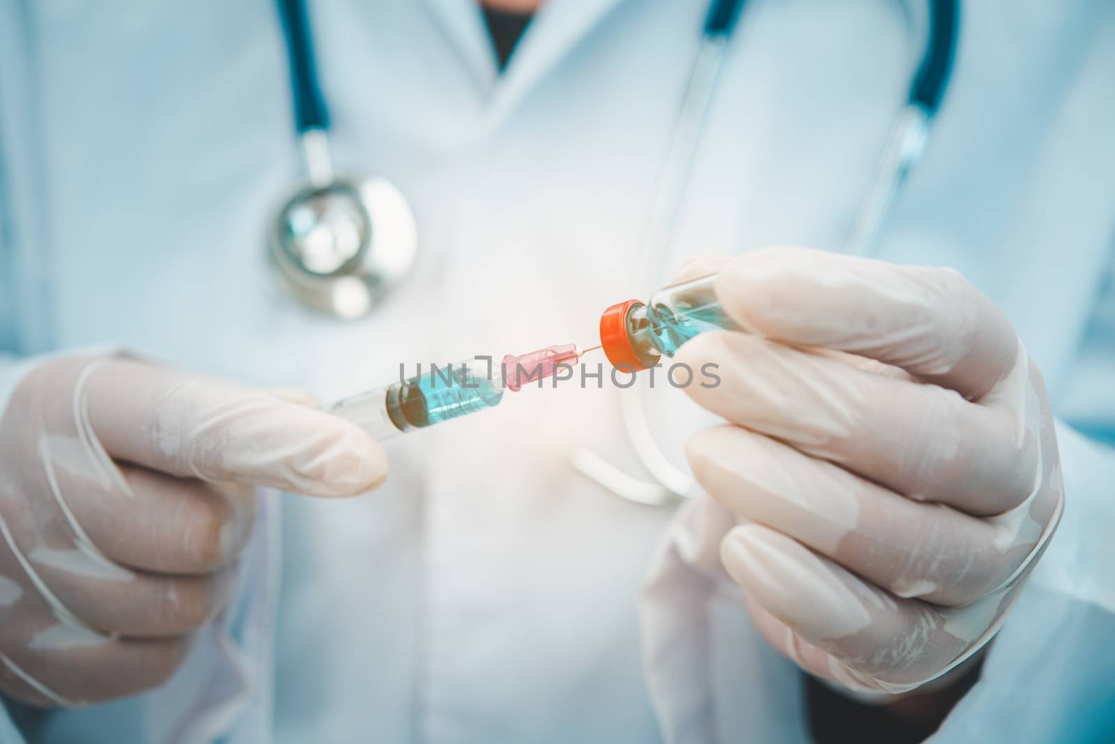 Doctor with syringe ready for injection of vaccine to patient. V by photobyphotoboy