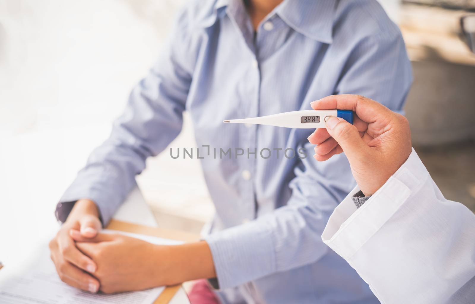 Doctors use thermometer to find patient's' condition as a treatment approach.