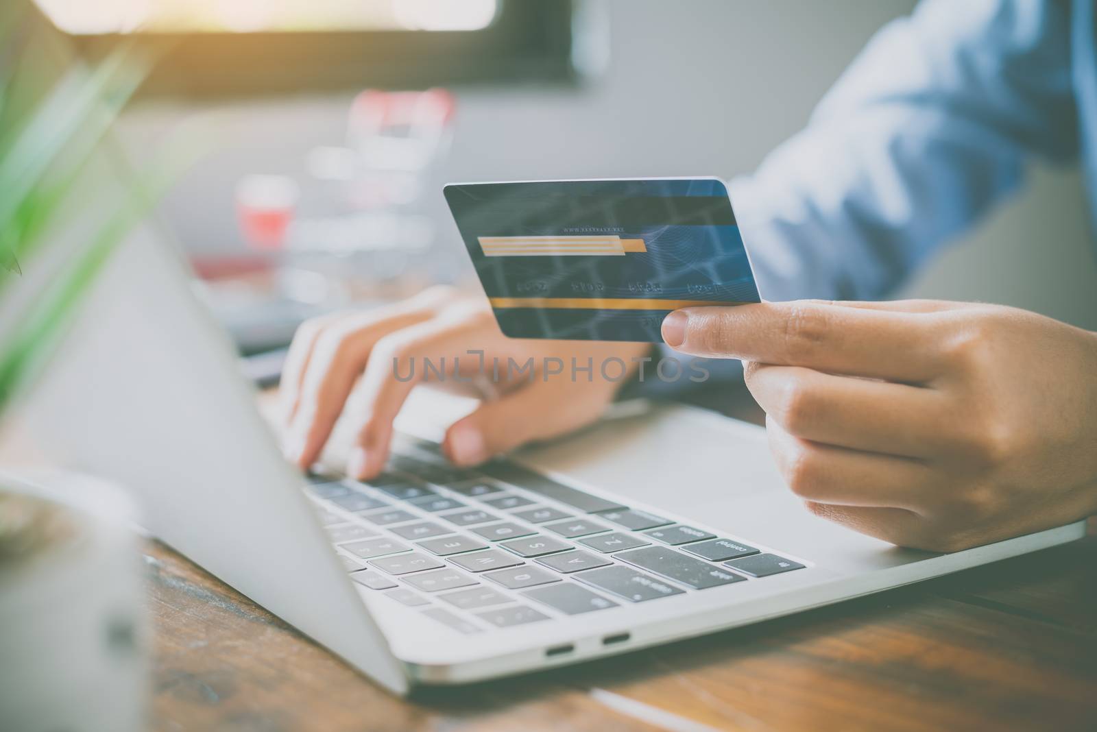 Woman holding credit cards and mobile phones are now shopping over the internet by paying by credit card.