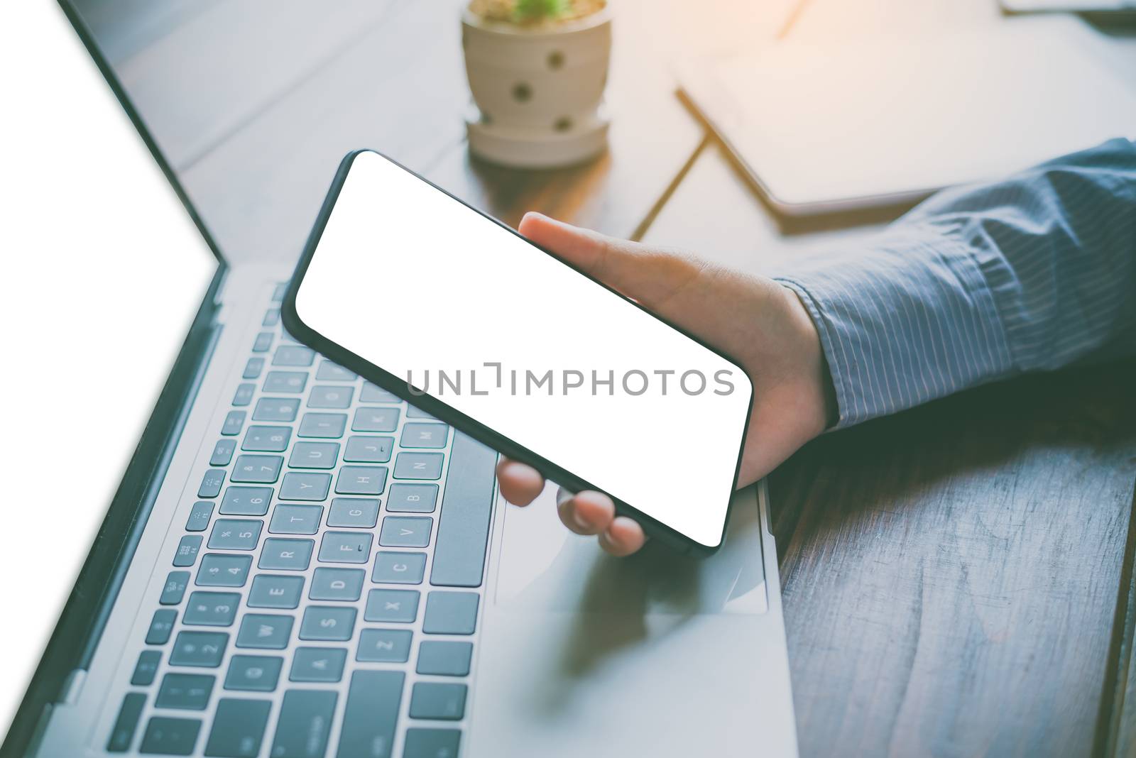 close-up mockup image of  hand holding black mobile phone with b by photobyphotoboy