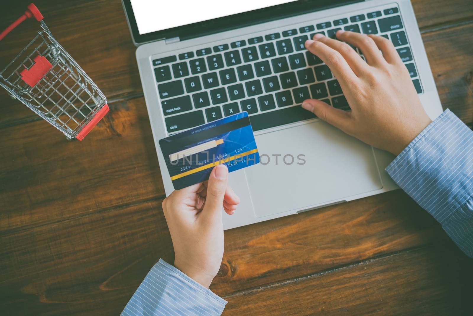 Woman holding credit cards and mobile phones are now shopping over the internet by paying by credit card.