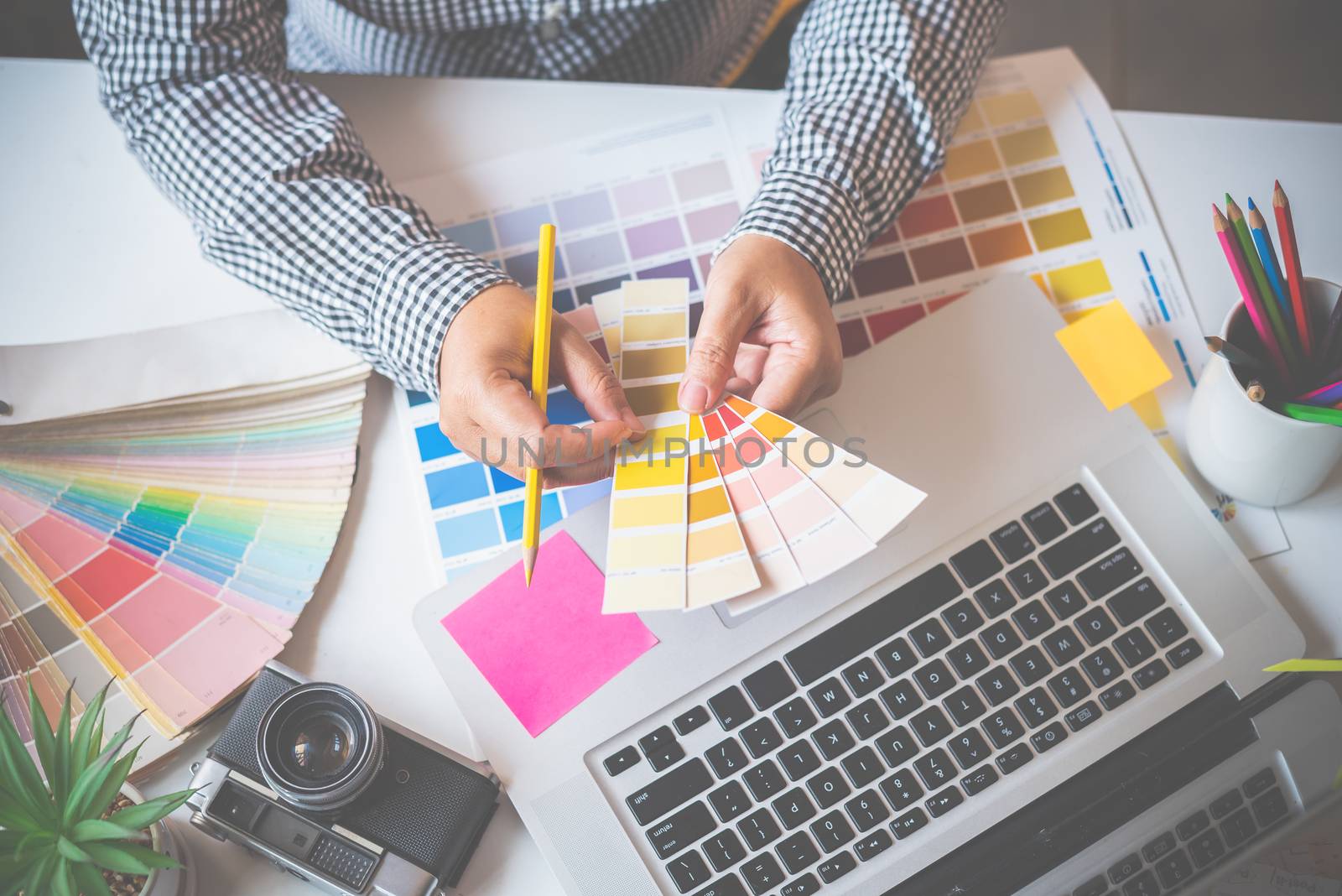 The graphic designer creative team is currently working on the design and color selection on the guide color for advertising design.