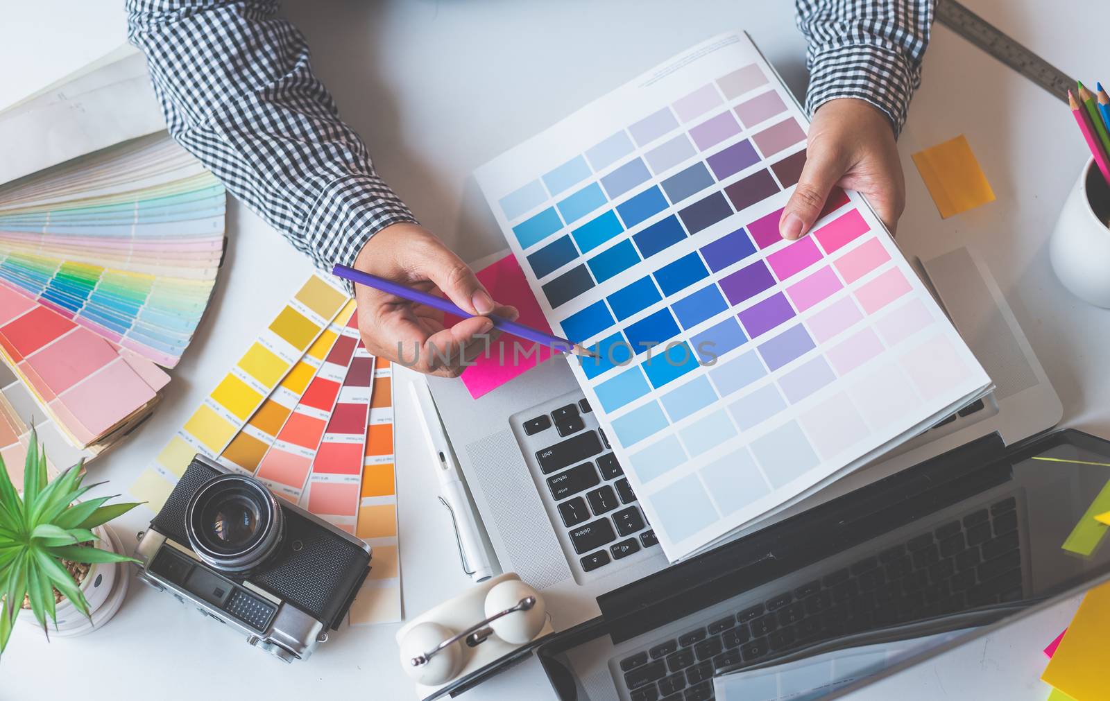 The graphic designer creative team is currently working on the design and color selection on the guide color for advertising design.