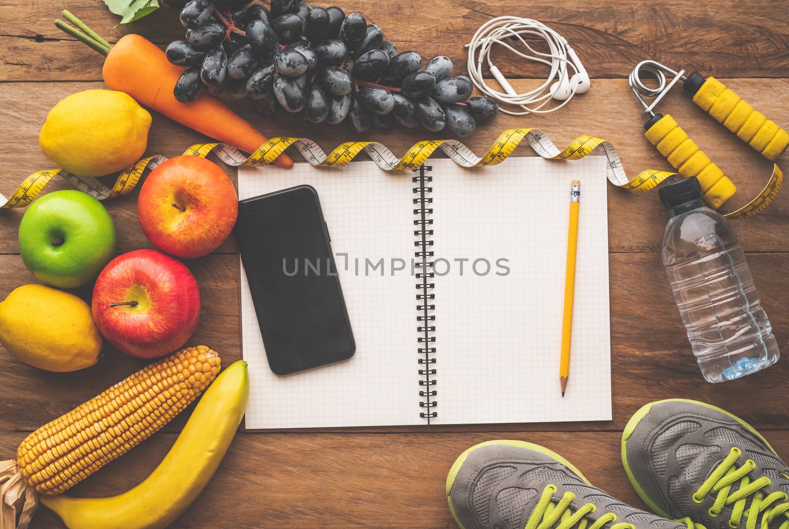 fitness concept with Exercise Equipment on wooden background.