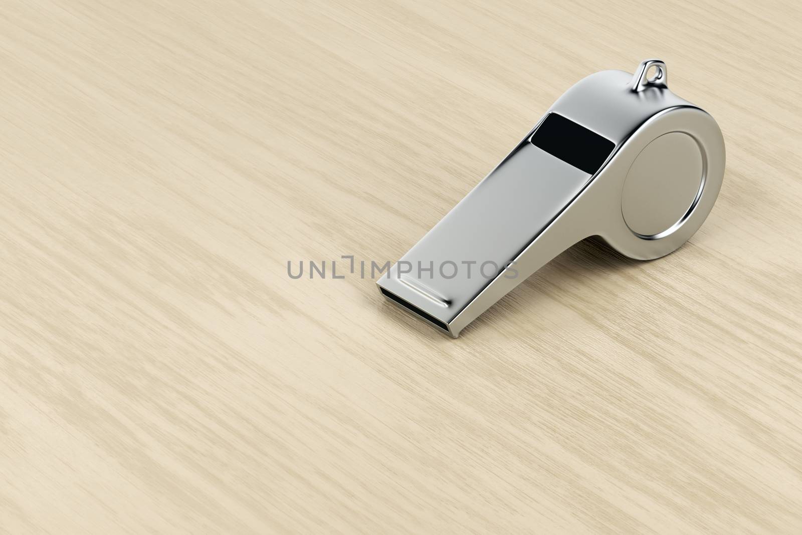 Silver referee whistle on wood desk