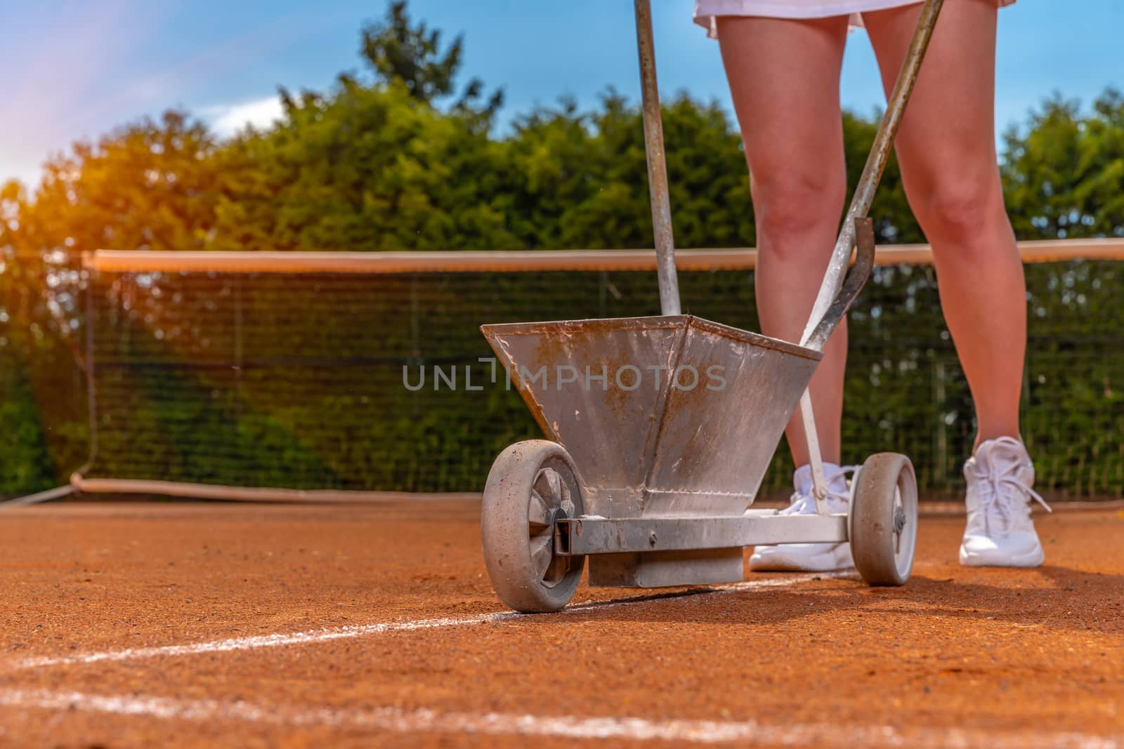 maintenance and repair of tennis courts. drawing white lines with lime.