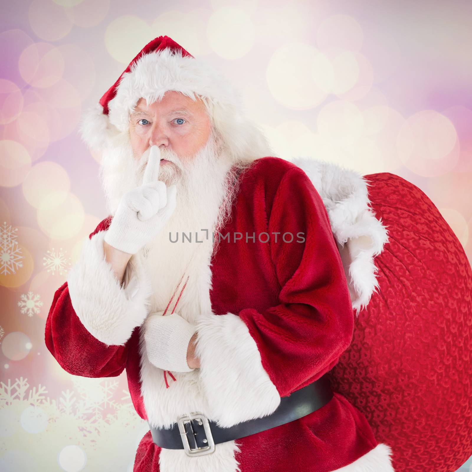 Santa asking for quiet with bag against glowing christmas background