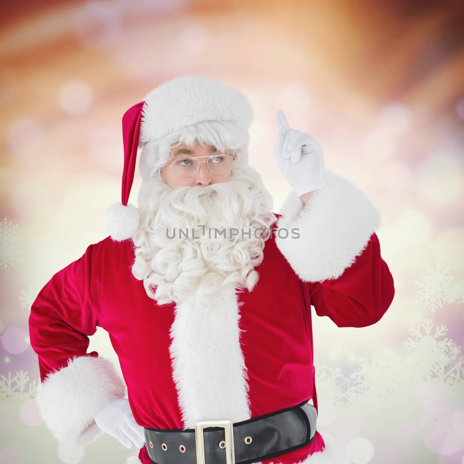 Serious santa claus pointing his finger against glowing christmas background