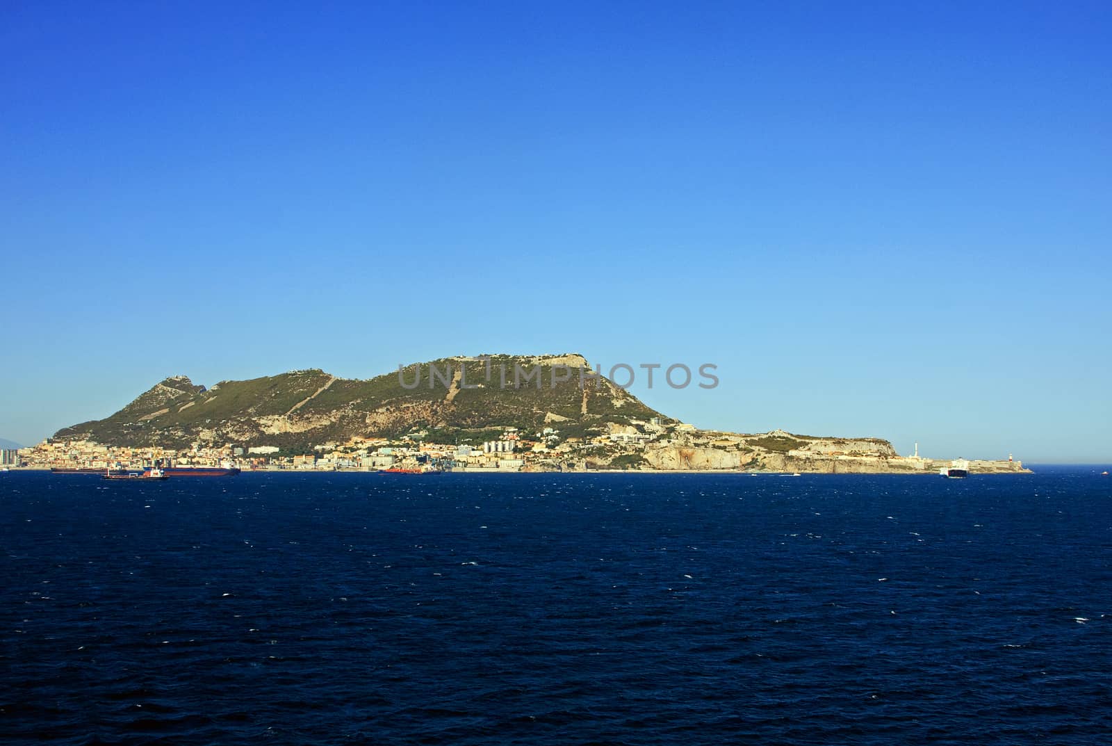 Gibraltar is a British territory located to the south of the Iberian Peninsula at the entrance to the Mediterranean Sea.  The land is one of the most southerly points in Europe.