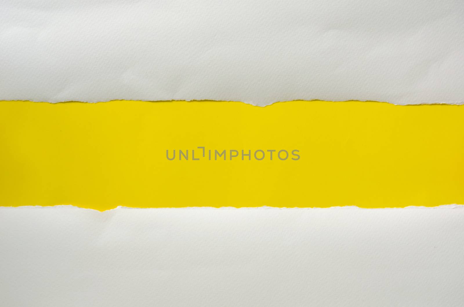 The paper is torn on a yellow background and there is a cutoff t by photobyphotoboy