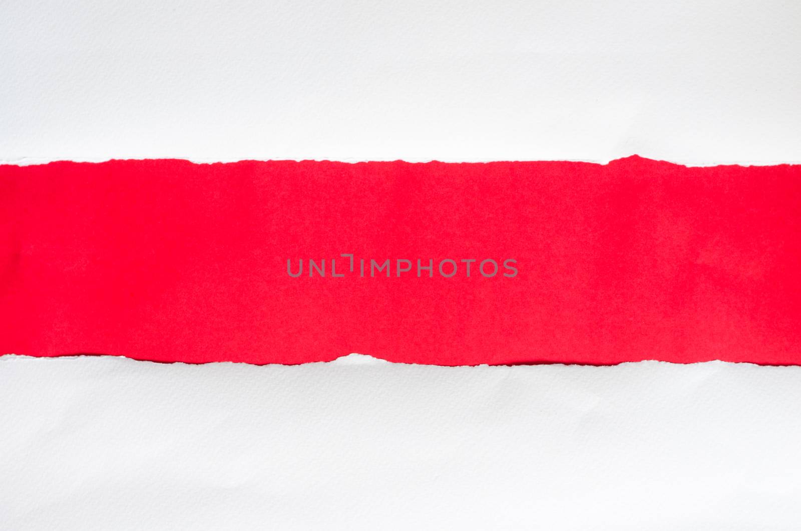 The paper is torn on a red background and there is a cutoff to t by photobyphotoboy