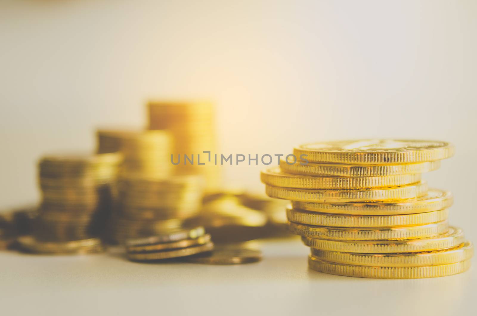 Many gold coins and golden light shine - the idea of saving for  by photobyphotoboy