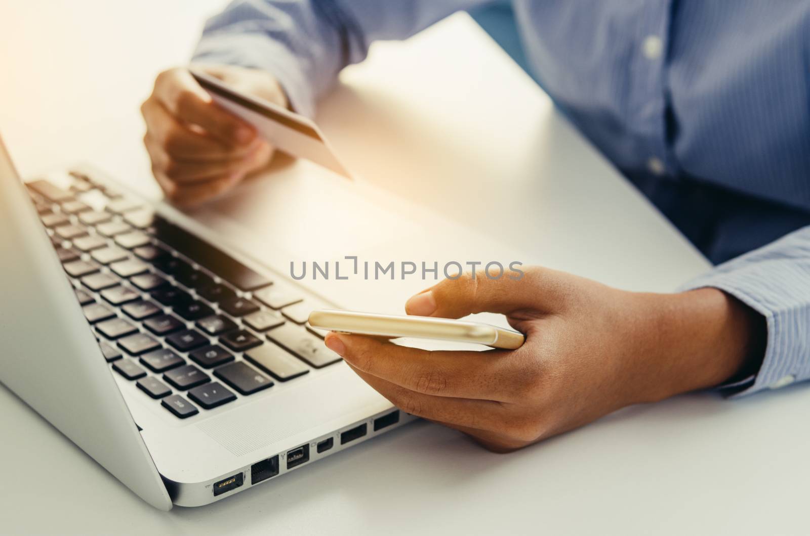 Hand holding credit cards and using laptops purchased order and payment with technology