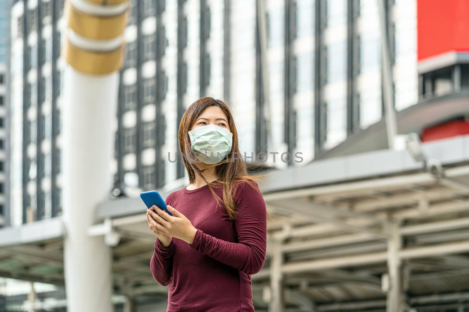 Asian woman hand using smart mobile phone with safety medical fa by Tzido