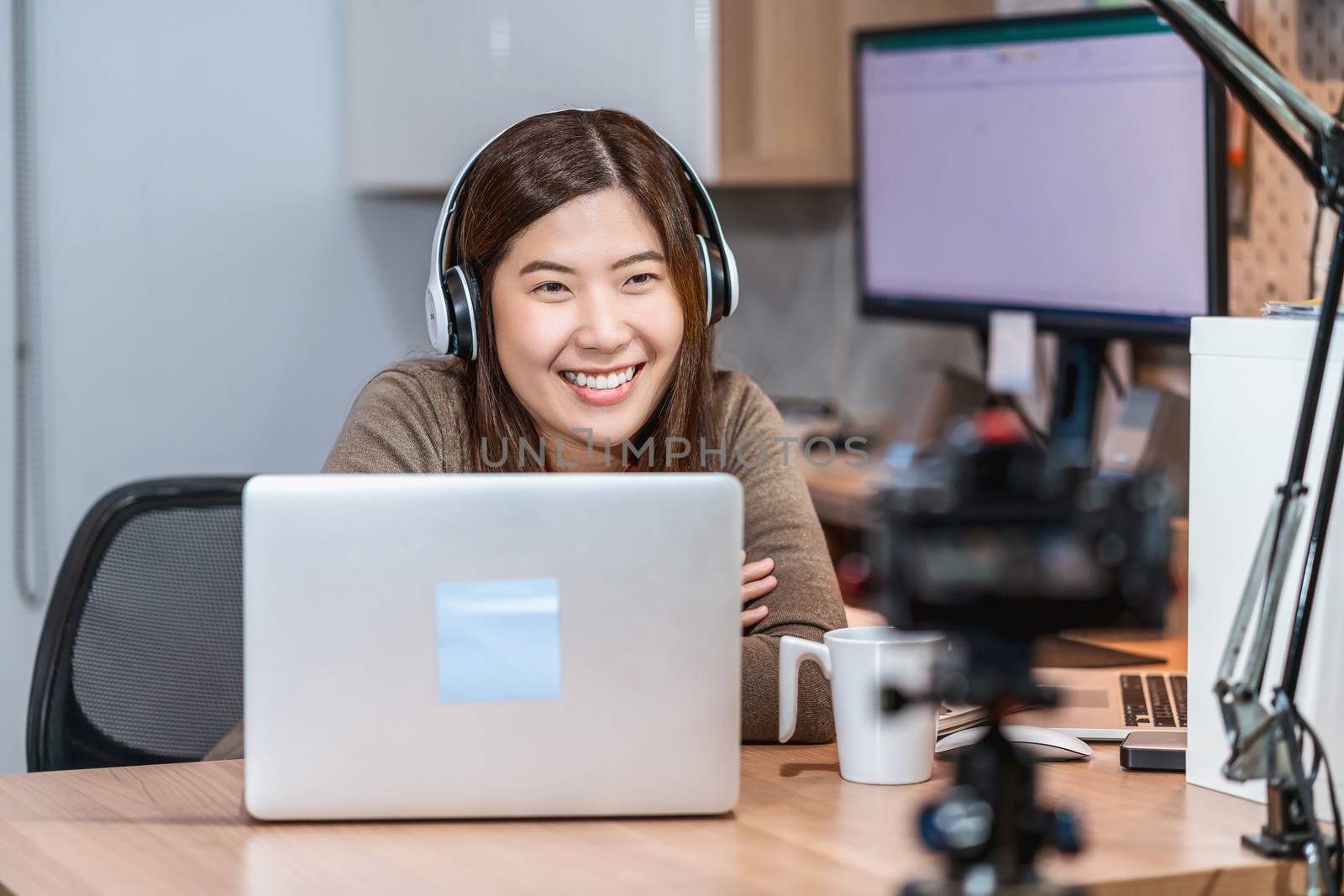 Asian business woman using technology laptop and working from ho by Tzido