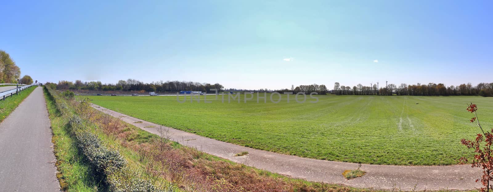 Beautiful high resolution panorama of a northern european country landscape with fields and green grass.