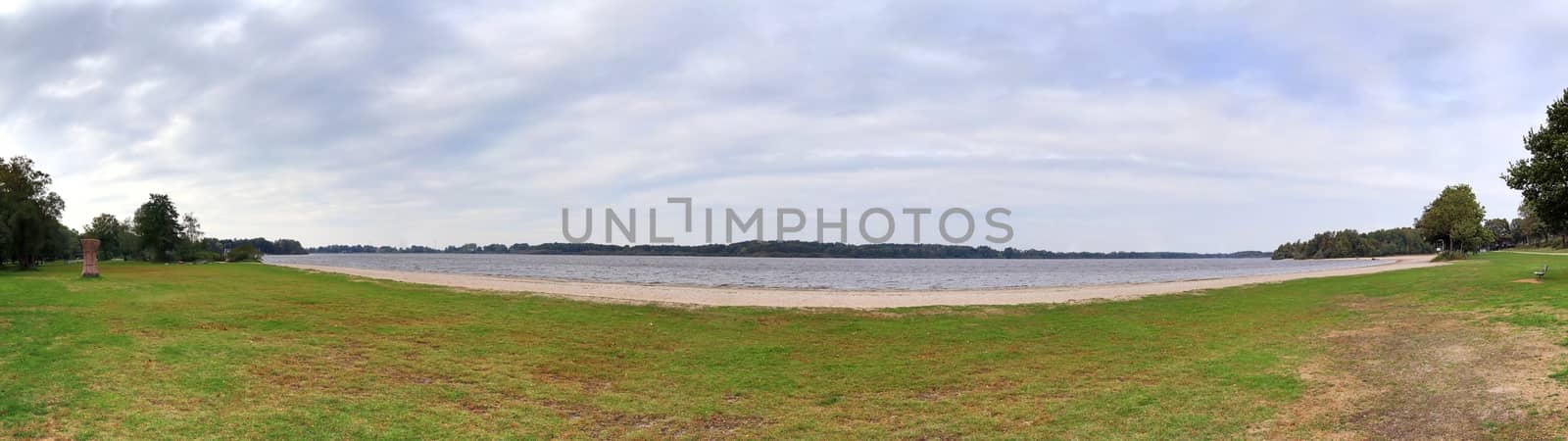 Beautiful high resolution panorama of a northern european country landscape with fields and green grass.