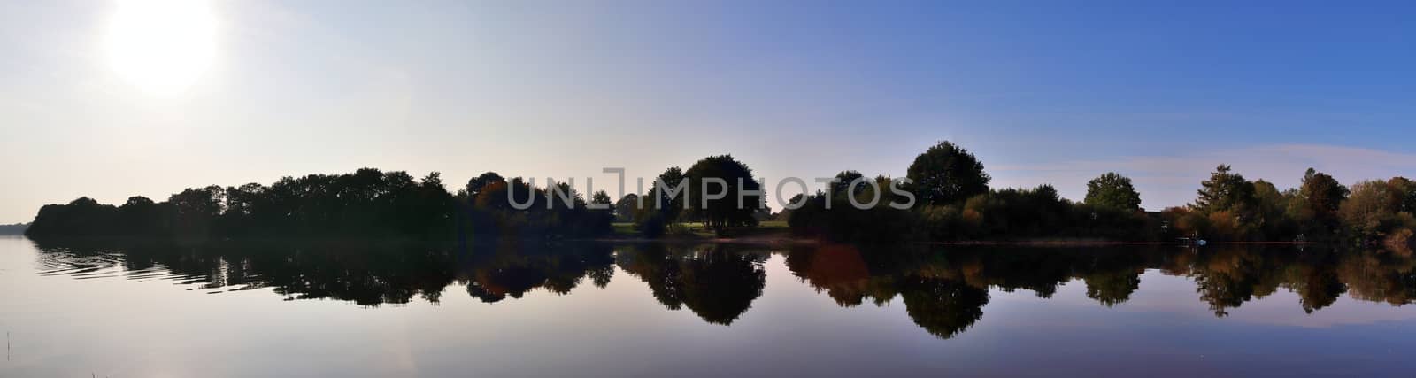 Beautiful high resolution panorama of a northern european country landscape with fields and green grass.