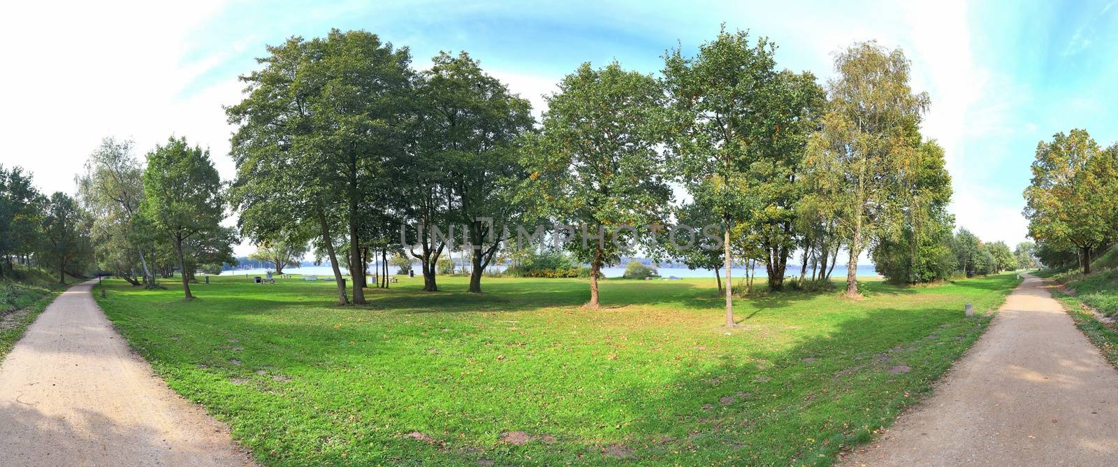 Beautiful high resolution panorama of a northern european country landscape with fields and green grass.